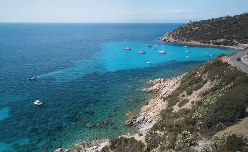High angle view of sailboats on sea shore against sky