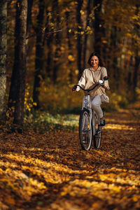 Portrait of woman riding bicycle on road