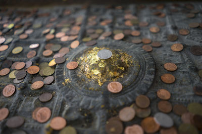 High angle view of coins on wood