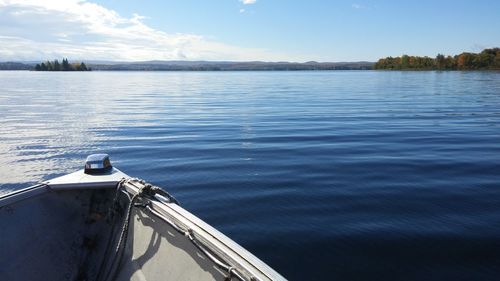 Boat moored in lake against sky
