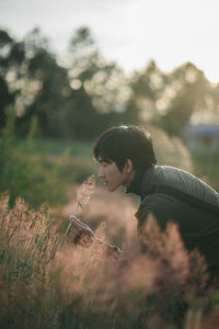 Man smelling flowers