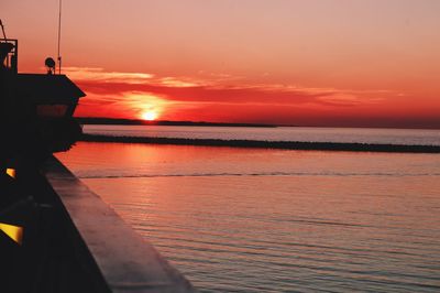 Scenic view of sea against orange sky