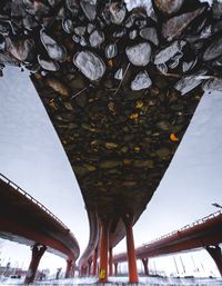 Low angle view of bridge in city against sky