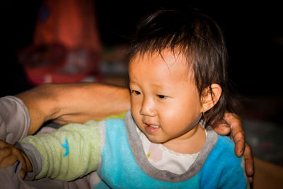 Cute little girl smiling face to her grandfather