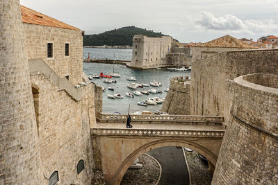 Bridge over sea against buildings in city