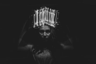 Portrait of young woman in darkroom