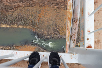 Low section of person standing in water