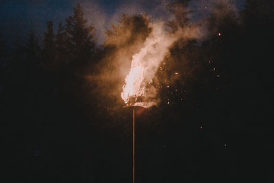 Low angle view of firework display at night