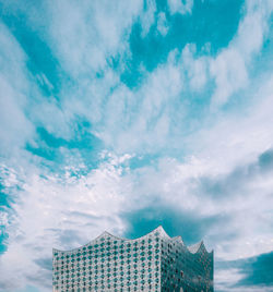 Low angle view of building against cloudy sky