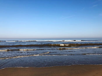 Scenic view of sea against clear blue sky