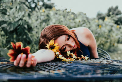 Portrait of woman with red flowers