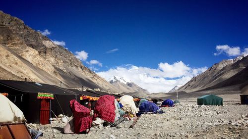 Tents in mountains against blue sky