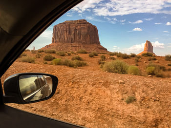 Reflection of rock formations on road