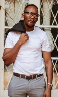 Full length portrait of young man standing outdoors