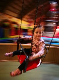 Full length of girl sitting outdoors
