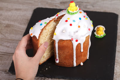 Easter cake on a slate stand,decorated with colored dragees, with sweet decorative figures of chicks