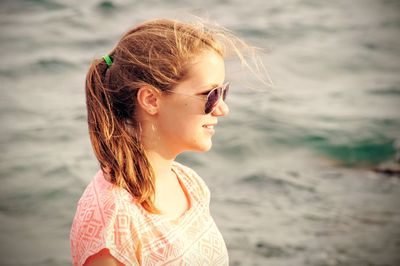 Close-up of teenage girl standing at beach