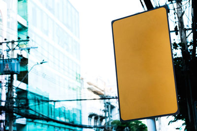 Low angle view of road sign against buildings