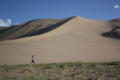 Walking alone into the tranquility  of quiet gobi desert, south mongolia. 