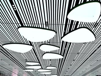 Low angle view of illuminated ceiling lights