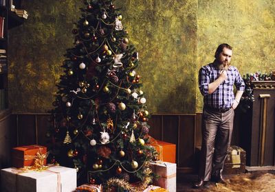 Portrait of man standing against wall