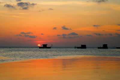 Scenic view of sea against orange sky