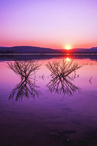 Scenic view of lake against romantic sky at sunset