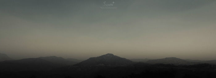 Scenic view of mountains against sky at dusk