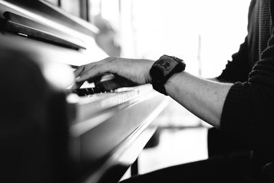 Close-up of man playing piano