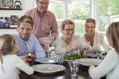 Multi-generation family having lunch together at home