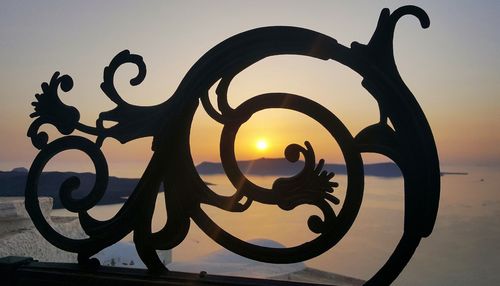 Close-up of silhouette water against sunset sky