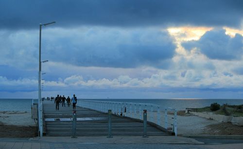 People on beach against sky