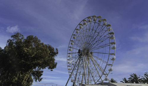 Low angle view of ferris wheel against sky