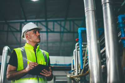 Mature man examining in factory