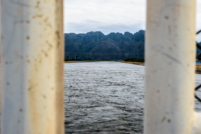 Scenic view of sea against sky seen through window