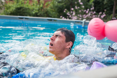 Portrait of man swimming in pool