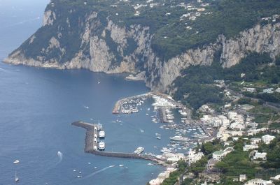 High angle view of city by sea against sky