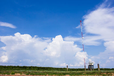 Low angle view of windmill on field against sky