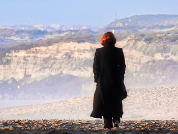 Rear view of man standing on mountain