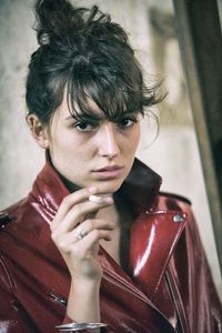 Portrait of young man smoking cigarette