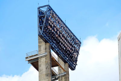 Low angle view of floodlight against sky