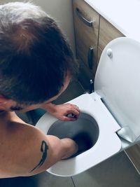 High angle view of man in bathroom