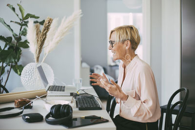 Profile of woman attending video conference at home