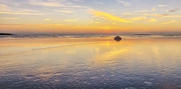 Scenic view of calm sea at sunset
