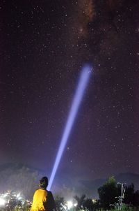 Low angle view of man against star field at night