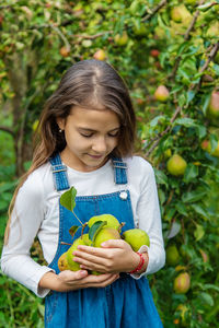 Portrait of young woman holding apple