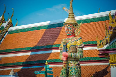 Low angle view of statue against temple building