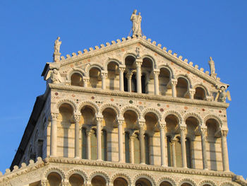 Low angle view of historical building against blue sky