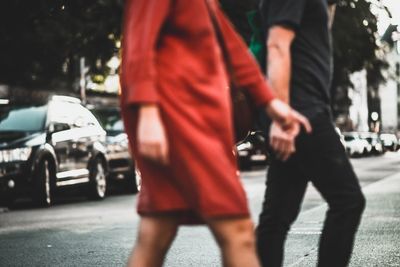 Low section of people walking on road