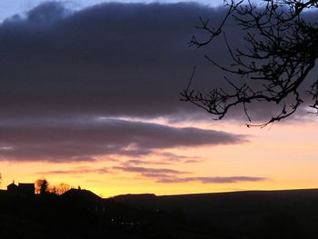 Silhouette of trees against dramatic sky